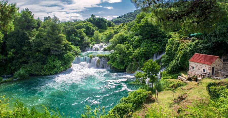 From Split: Krka Waterfalls Tour with Boat Ride & Swimming - Walking the wooden paths around Skradinski Buk