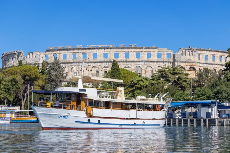 Pula: Brijuni National Park Sunset, Dolphins & Dinner Cruise - Returning to Pula and the Arena after dark